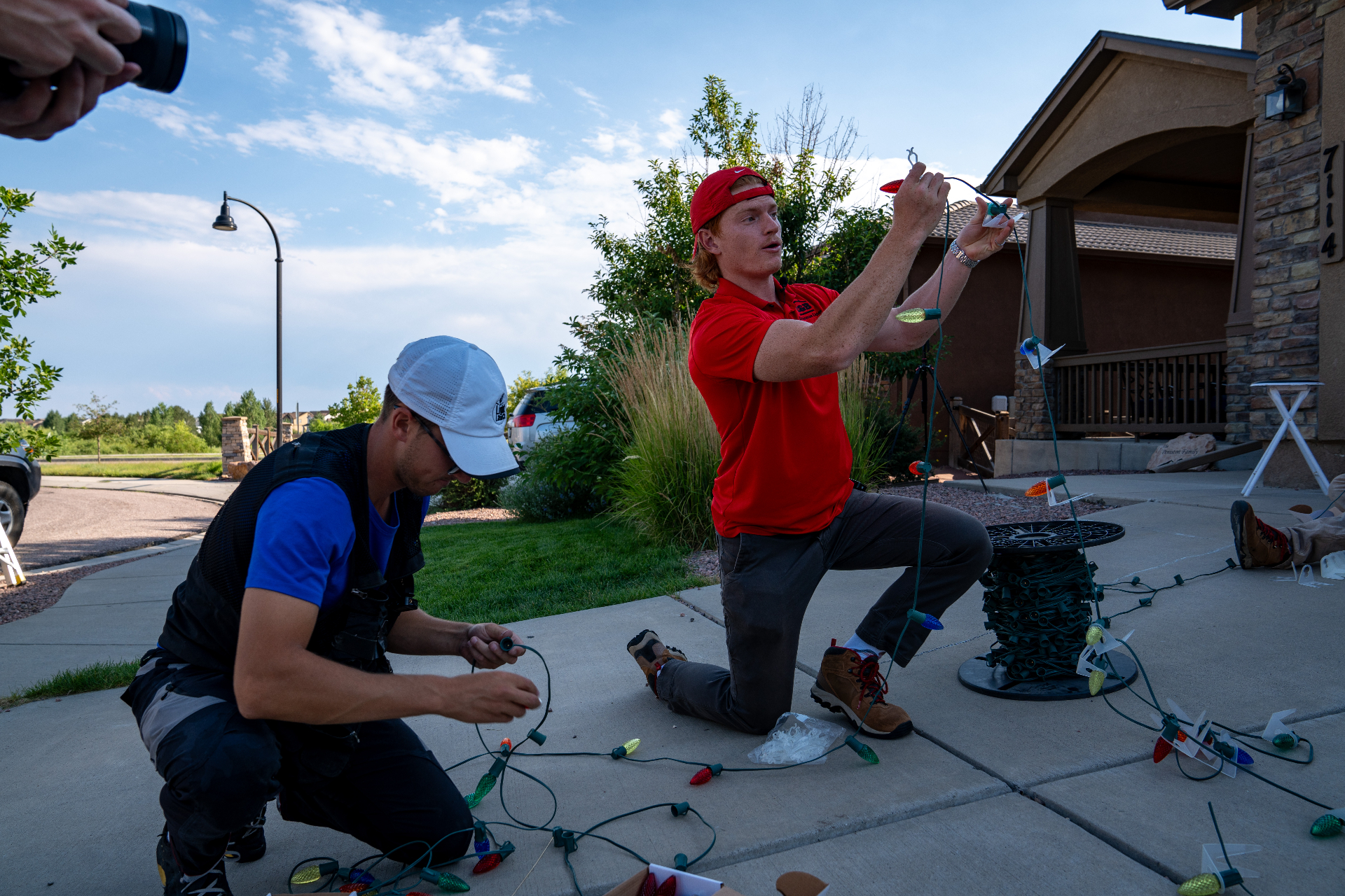 Christmas City Holiday Lighting installer hanging Christmas lights on a roofline